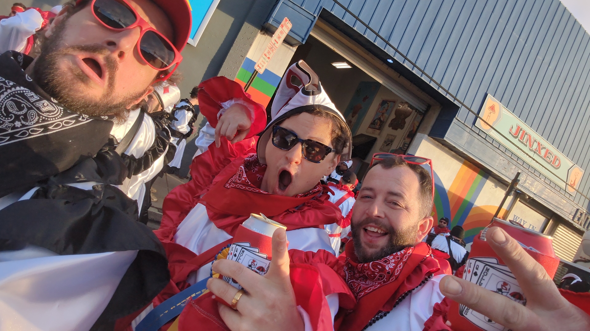 Three revelers in red and white parade costumes on New Year’s Day